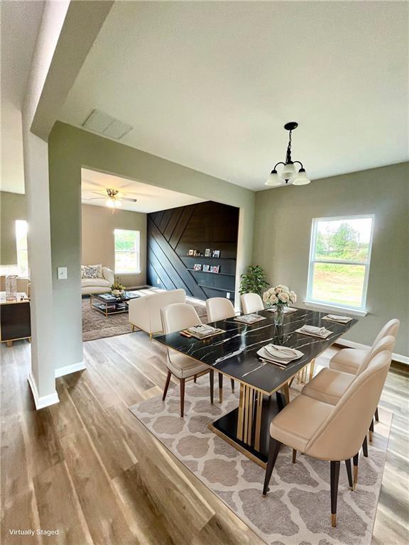 dining room with wood-type flooring and a chandelier