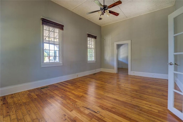 spare room with wood-type flooring and ceiling fan