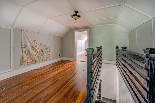 additional living space featuring wood-type flooring and vaulted ceiling