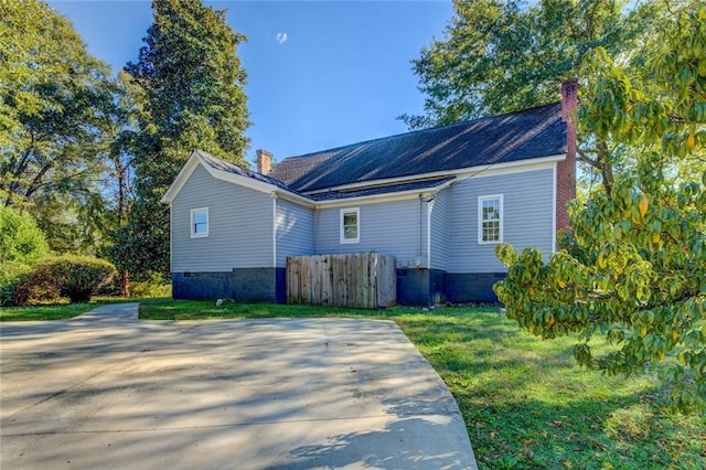 back of house with a lawn