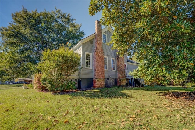 view of side of home featuring a lawn
