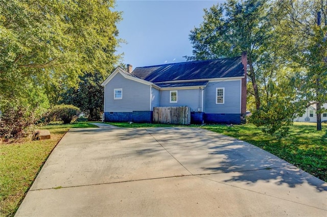 back of property featuring a lawn