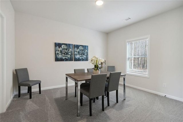 dining room with baseboards, carpet flooring, and visible vents