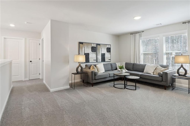 carpeted living area with visible vents, recessed lighting, and baseboards