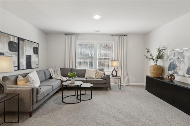 carpeted living area with baseboards and visible vents