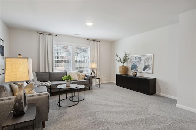 carpeted living room with baseboards