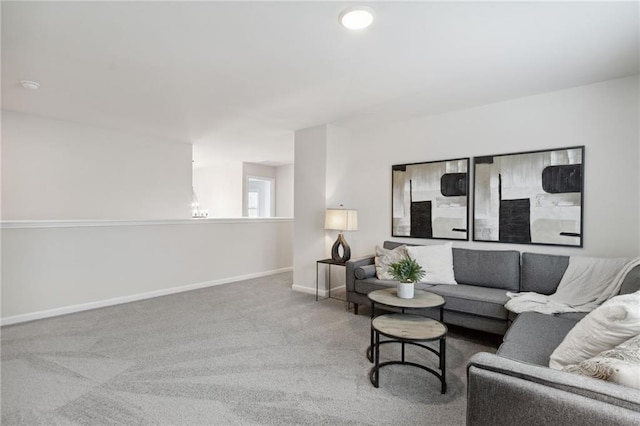 living area featuring baseboards and carpet