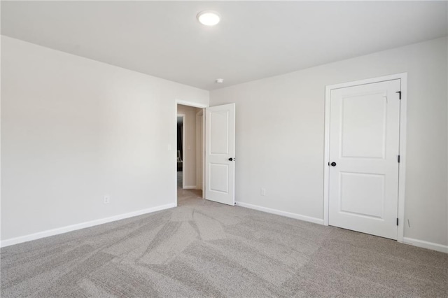 carpeted spare room featuring baseboards and recessed lighting