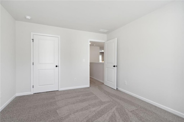 unfurnished bedroom with baseboards and carpet floors