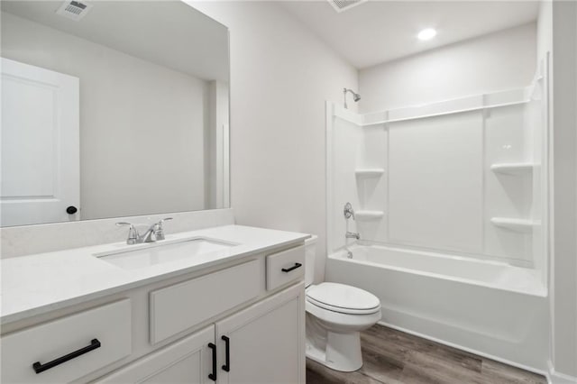 bathroom featuring vanity, shower / bathtub combination, toilet, wood finished floors, and visible vents