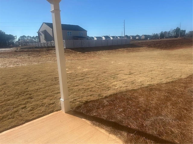 view of home's community featuring fence