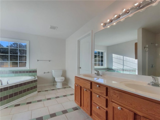 bathroom with a relaxing tiled tub, tile patterned flooring, toilet, and vanity