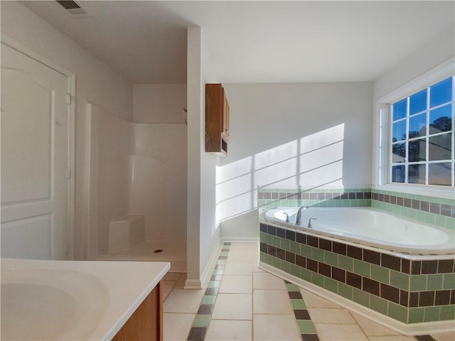 bathroom with tile patterned floors, vanity, and shower with separate bathtub