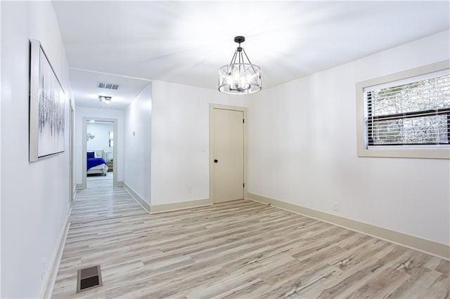 unfurnished dining area featuring visible vents, baseboards, and light wood finished floors