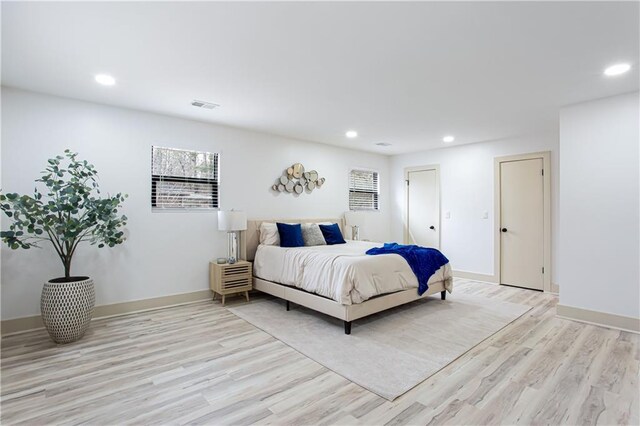 clothes washing area with baseboards, laundry area, electric dryer hookup, washer hookup, and light wood-style floors