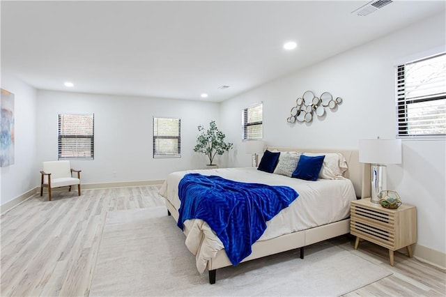 bedroom featuring recessed lighting, visible vents, baseboards, and wood finished floors