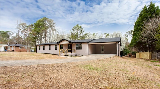 ranch-style house with a front yard, fence, driveway, crawl space, and brick siding