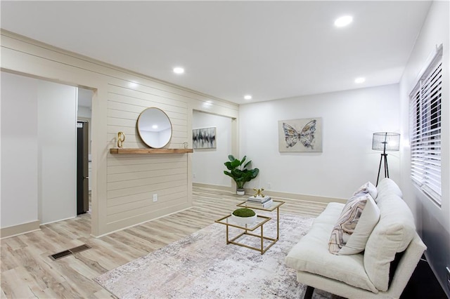 living room with recessed lighting, wood finished floors, and visible vents