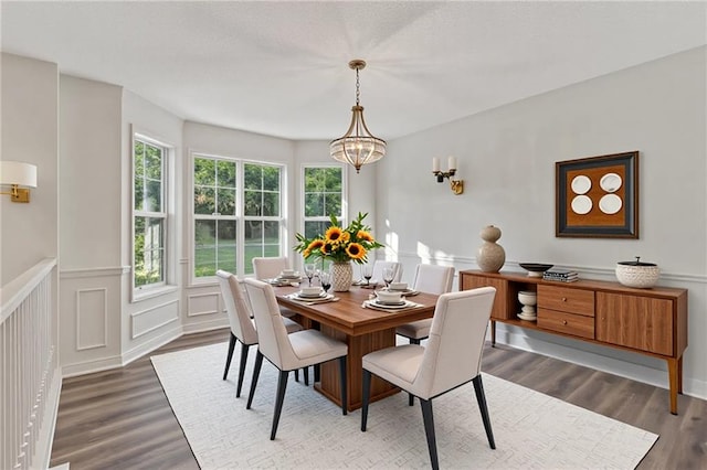 733 Wesley Chapel Rd, Villa Rica, GA 30180 - dining space with wood finished floors, a wainscoted wall, a decorative wall, and a chandelier