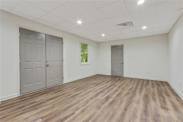 733 Wesley Chapel Rd, Villa Rica, GA 30180 - unfurnished bedroom with wood finished floors, a drop ceiling, and recessed lighting