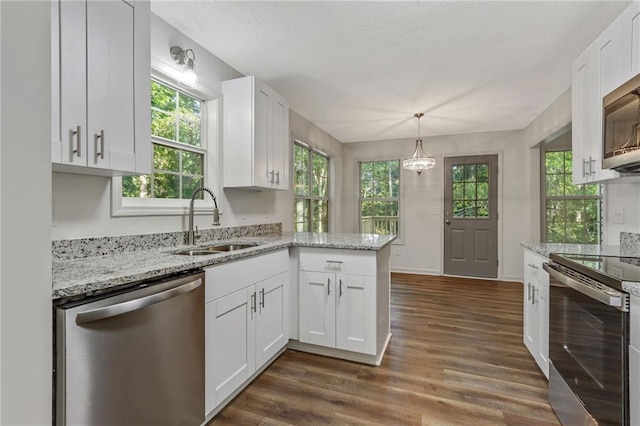 733 Wesley Chapel Rd, Villa Rica, GA 30180 - kitchen featuring appliances with stainless steel finishes, white cabinetry, a peninsula, and light stone counters