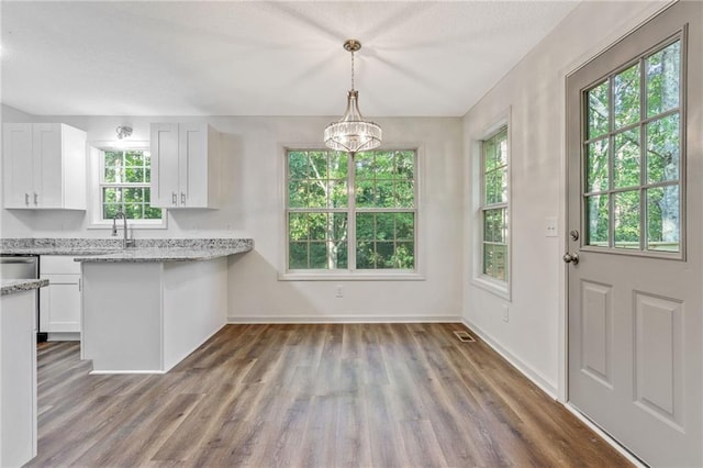 733 Wesley Chapel Rd, Villa Rica, GA 30180 - kitchen featuring white cabinetry, wood finished floors, and healthy amount of natural light