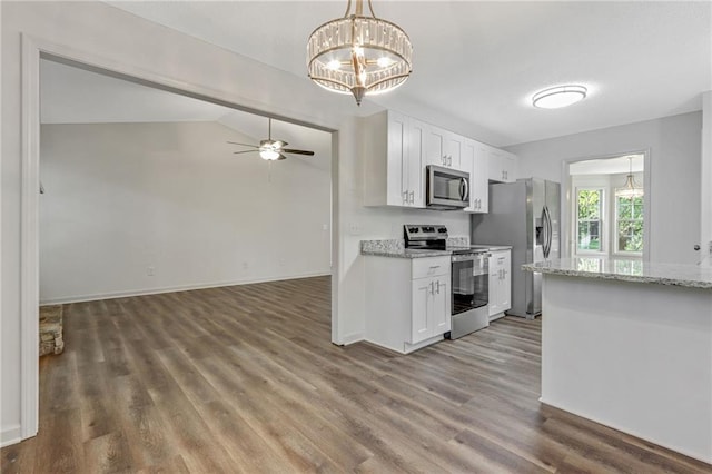 733 Wesley Chapel Rd, Villa Rica, GA 30180 - kitchen with stainless steel appliances, wood finished floors, white cabinets, a ceiling fan, and vaulted ceiling