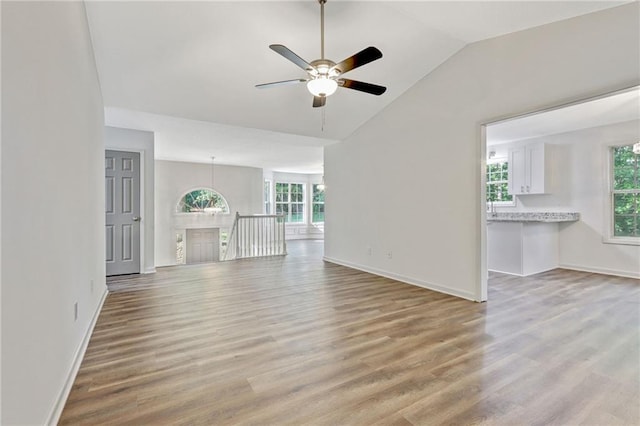 733 Wesley Chapel Rd, Villa Rica, GA 30180 - unfurnished living room with healthy amount of natural light, light wood-style flooring, ceiling fan, and lofted ceiling
