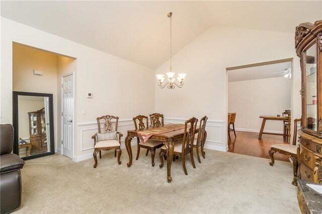 2623 Grapevine Cir Unit 602, Cumming, GA 30041 - carpeted dining room with a decorative wall, lofted ceiling, a notable chandelier, and a wainscoted wall