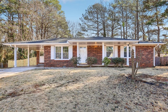 8298 Holly Dr, Jonesboro, GA 30238 - ranch-style home with brick siding, fence, an attached carport, and driveway