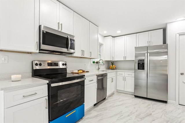 8298 Holly Dr, Jonesboro, GA 30238 - kitchen with white cabinets, marble finish floor, a sink, and appliances with stainless steel finishes