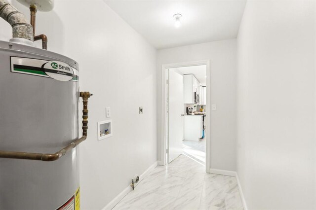 8298 Holly Dr, Jonesboro, GA 30238 - washroom featuring washer hookup, laundry area, electric dryer hookup, gas water heater, and marble finish floor