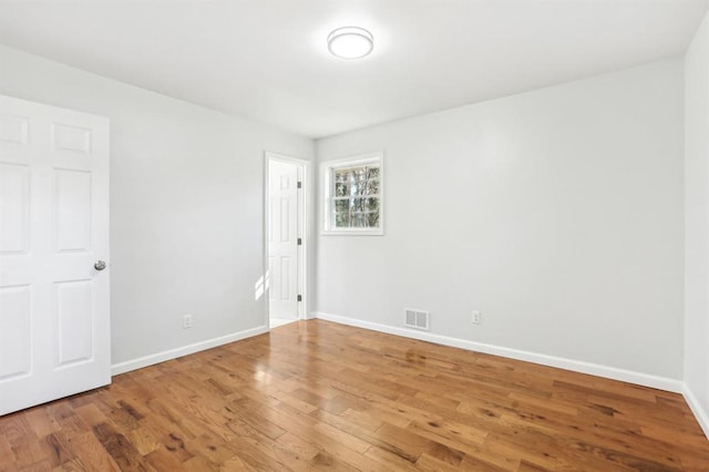 8298 Holly Dr, Jonesboro, GA 30238 - empty room featuring wood finished floors, baseboards, and visible vents