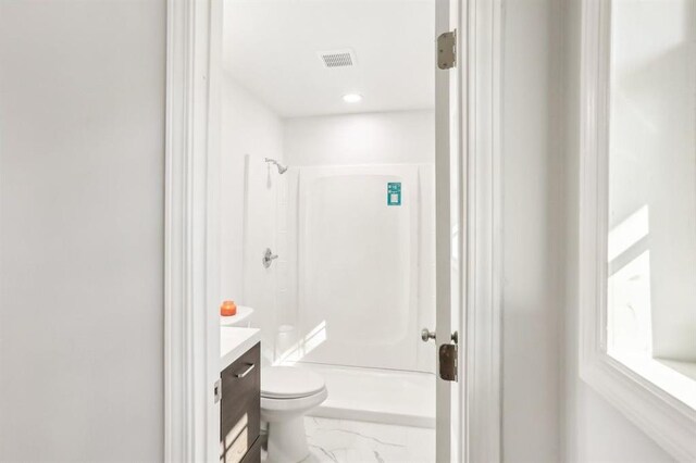 8298 Holly Dr, Jonesboro, GA 30238 - bathroom with vanity, toilet, visible vents, a shower, and marble finish floor
