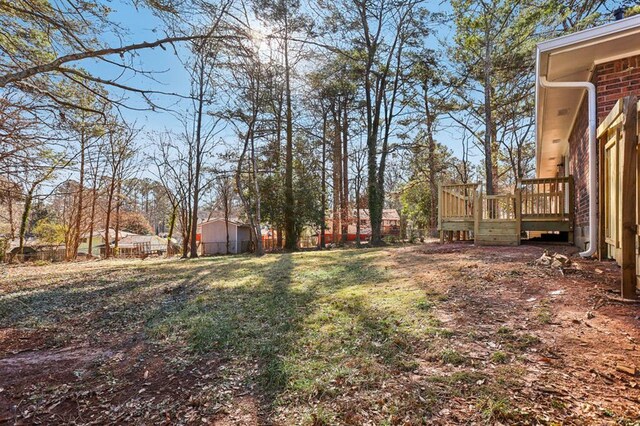 8298 Holly Dr, Jonesboro, GA 30238 - view of yard with fence and a deck