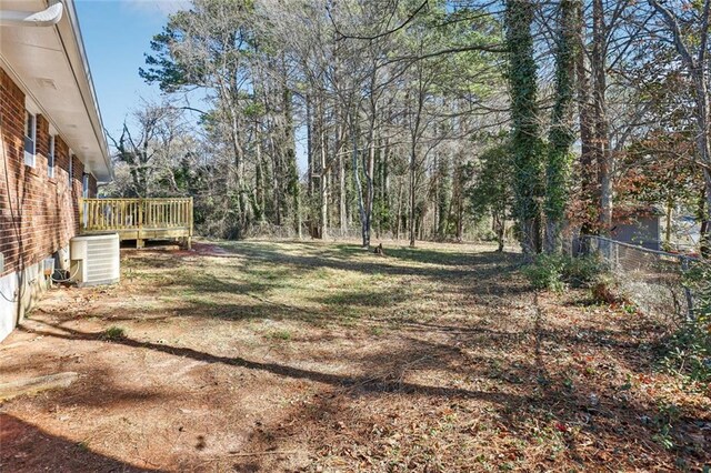 8298 Holly Dr, Jonesboro, GA 30238 - view of yard featuring central AC unit, fence, and a wooden deck