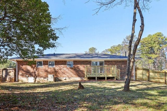 8298 Holly Dr, Jonesboro, GA 30238 - rear view of house with a deck, a lawn, fence, and brick siding
