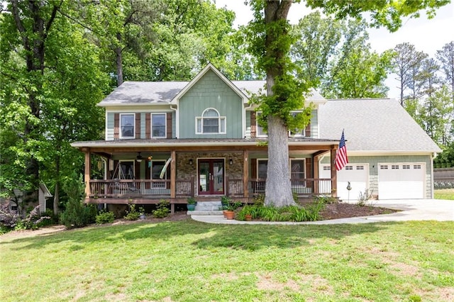 colonial-style house with a porch, a garage, concrete driveway, and a front lawn