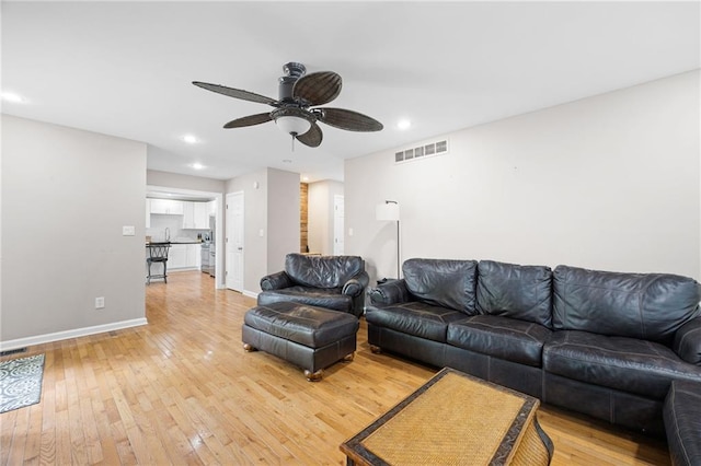 living room with visible vents, light wood-style floors, baseboards, ceiling fan, and recessed lighting