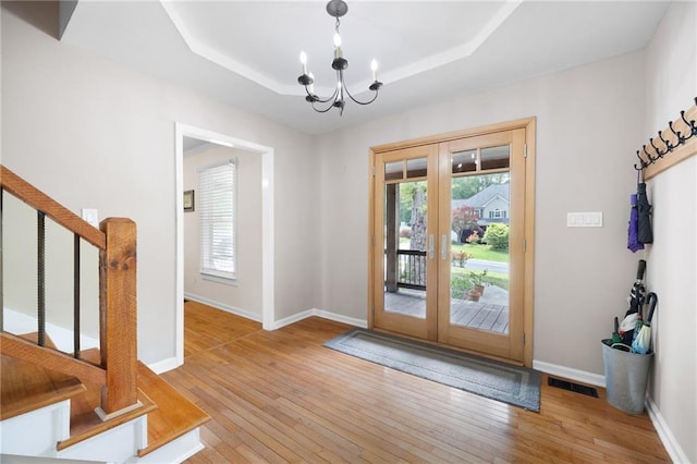 entryway featuring french doors, visible vents, stairway, baseboards, and a chandelier