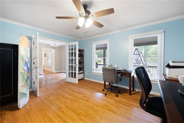 office featuring crown molding, plenty of natural light, french doors, light wood-style flooring, and ceiling fan with notable chandelier