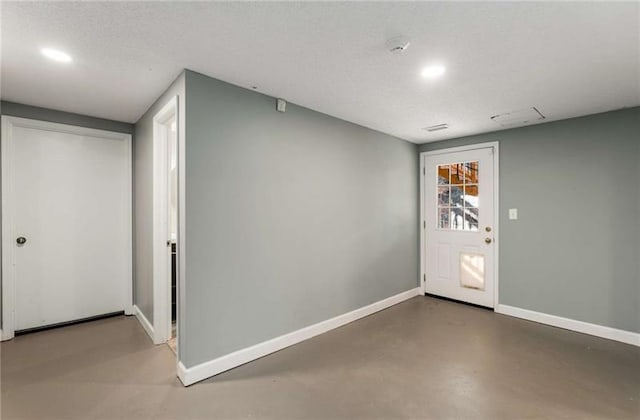 entryway featuring a textured ceiling and concrete floors