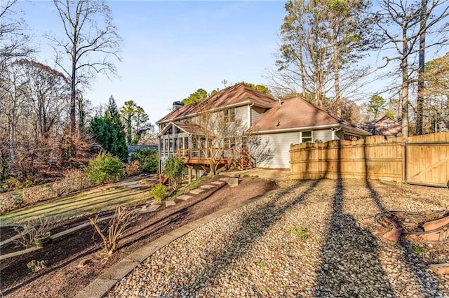 rear view of house featuring a wooden deck