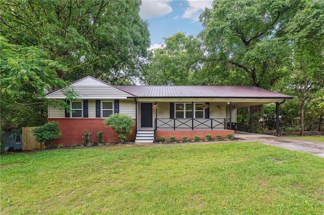 ranch-style home featuring a porch, driveway, a front yard, a carport, and brick siding
