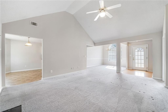 unfurnished living room featuring high vaulted ceiling, carpet flooring, visible vents, and ceiling fan with notable chandelier