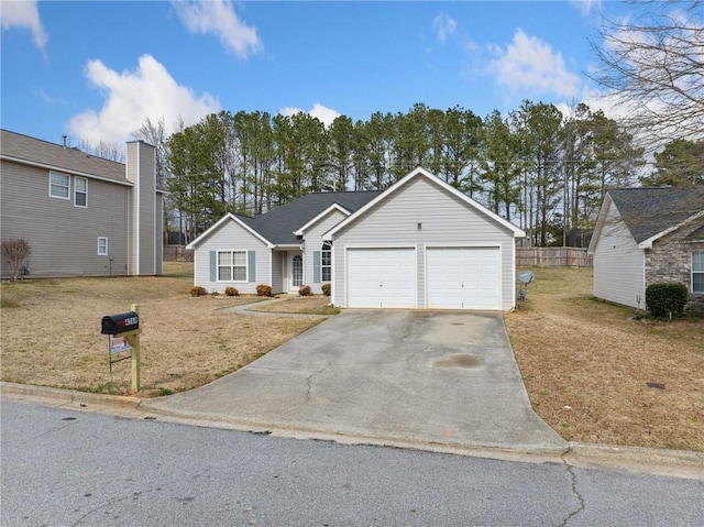 view of front of house featuring a garage, concrete driveway, and a front lawn