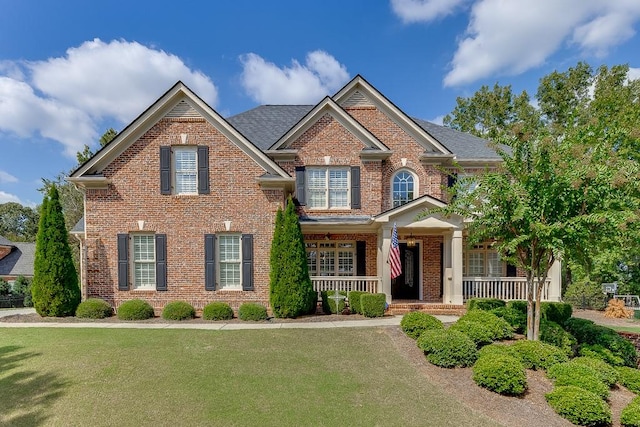 craftsman-style home with covered porch and a front yard