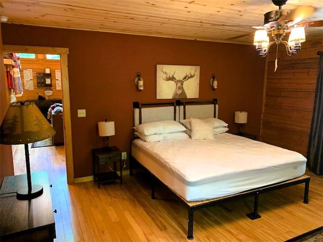 bedroom with wooden ceiling and light wood-type flooring