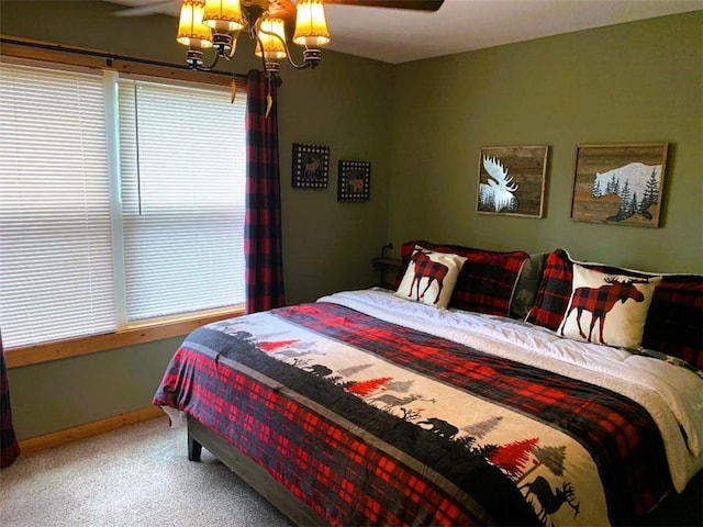 carpeted bedroom featuring ceiling fan and multiple windows