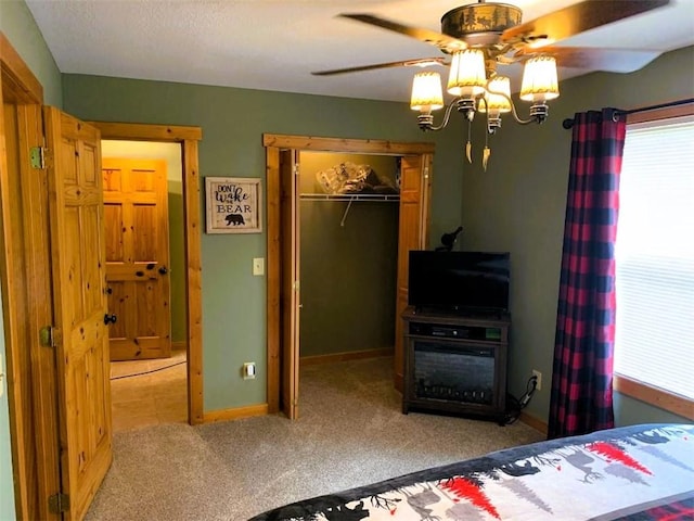 bedroom featuring carpet flooring, ceiling fan, and a closet